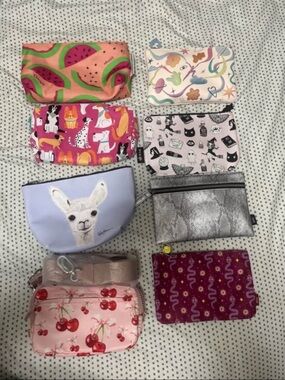 Ipsy Bags and other misc makeup bags and a cherry wallet.